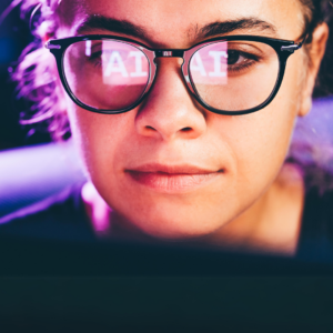 a woman with glasses looking at her phone with AI reflected in her glasses